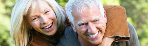 Older woman laughing with her husband while on his back