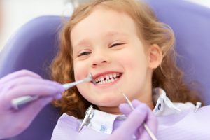 little girl getting a dental exam