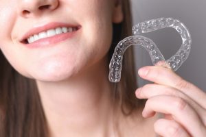 woman holding ClearCorrect Aligners 